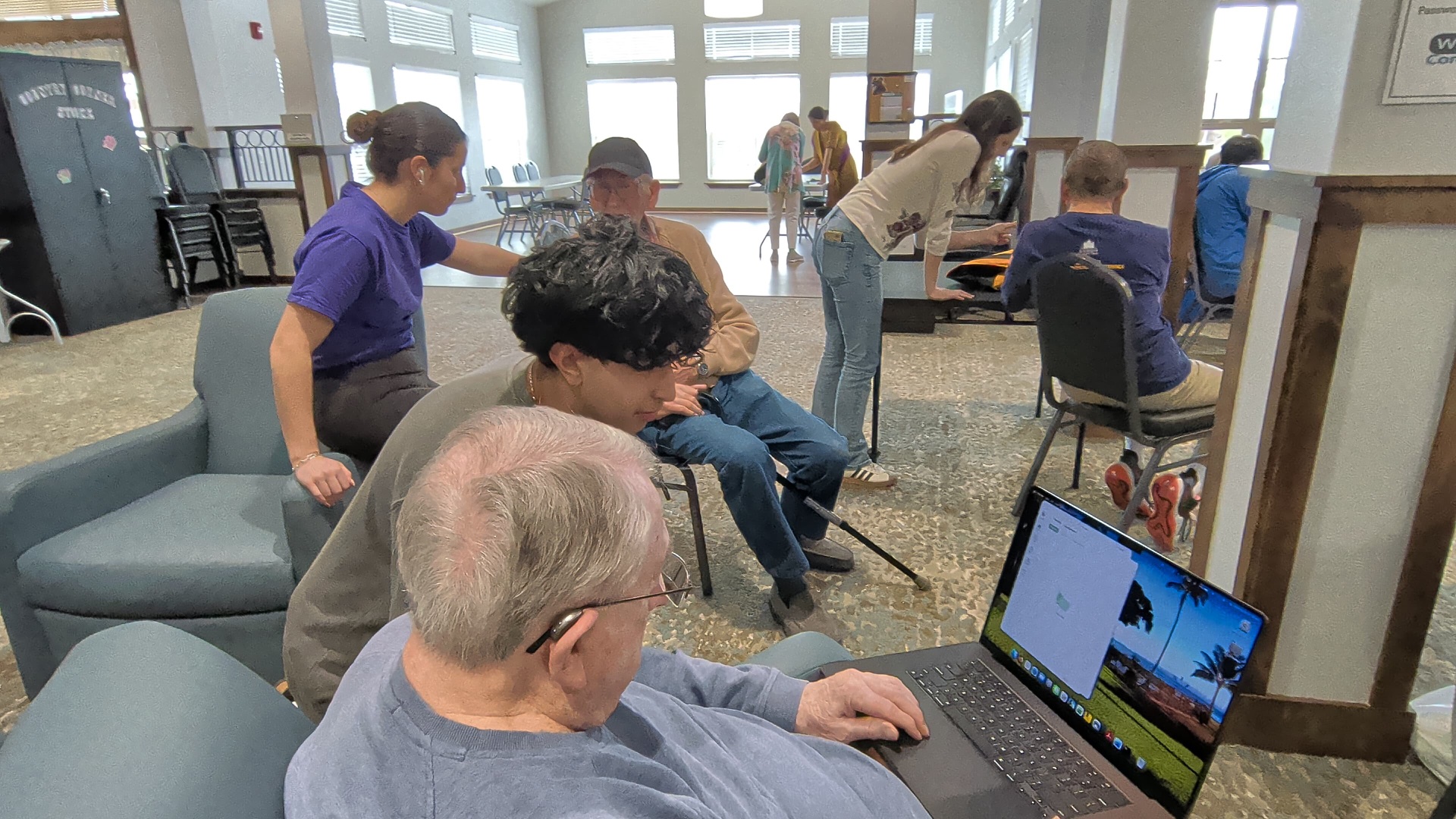 Pranil and other Tech4Silvers volunteers helping senior-center residents one-on-one with their devices.